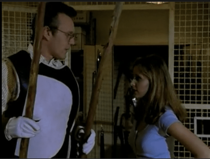 Giles and Buffy in front of the library cage